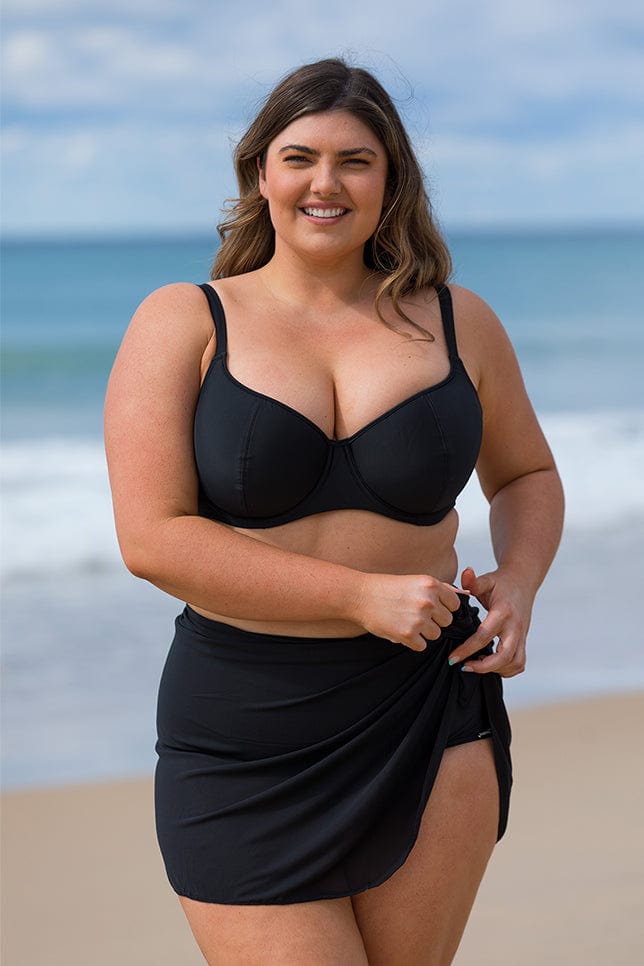 Brunette model wears modest black mesh tie swim skirt