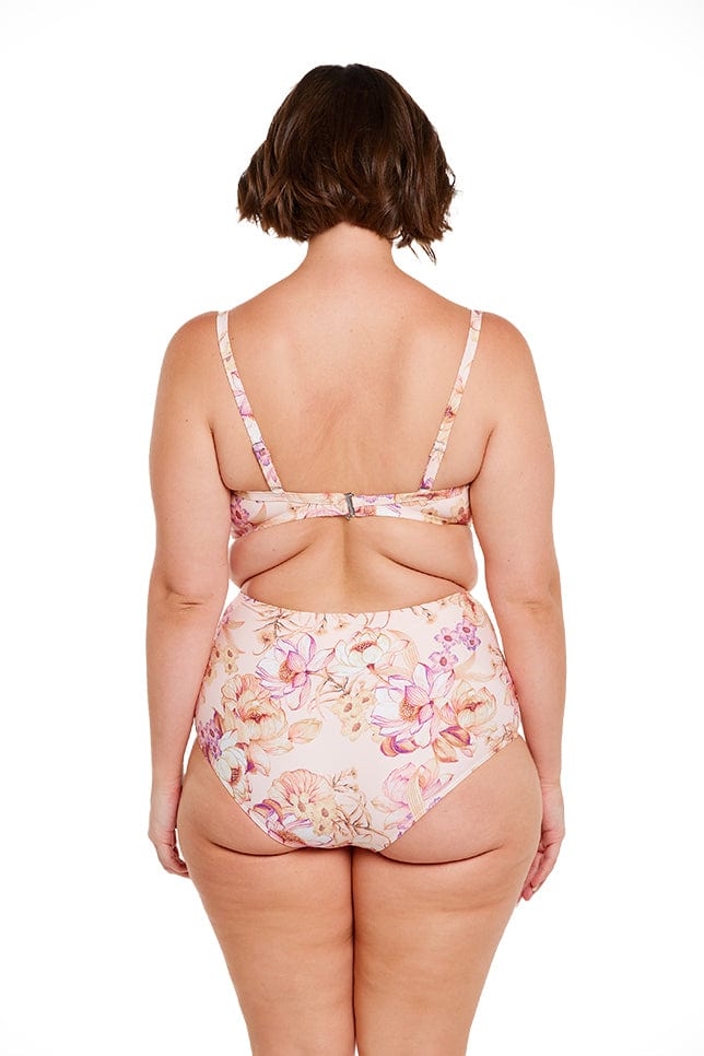 brunette model wears peach floral high waisted bikini bottom with tummy control