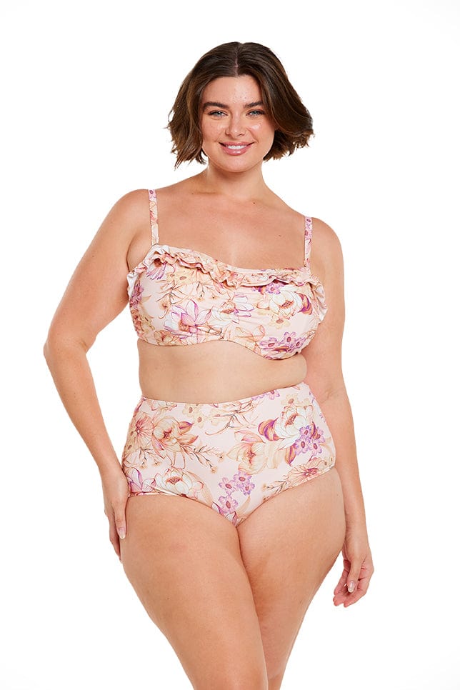 Brunette women wears strapless bandeau underwire bikini in peach floral print