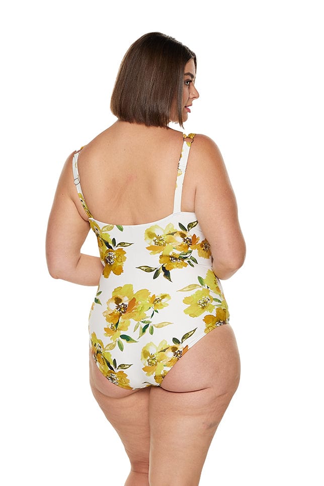 brunette women wearing yellow and white floral one piece with adjustable straps
