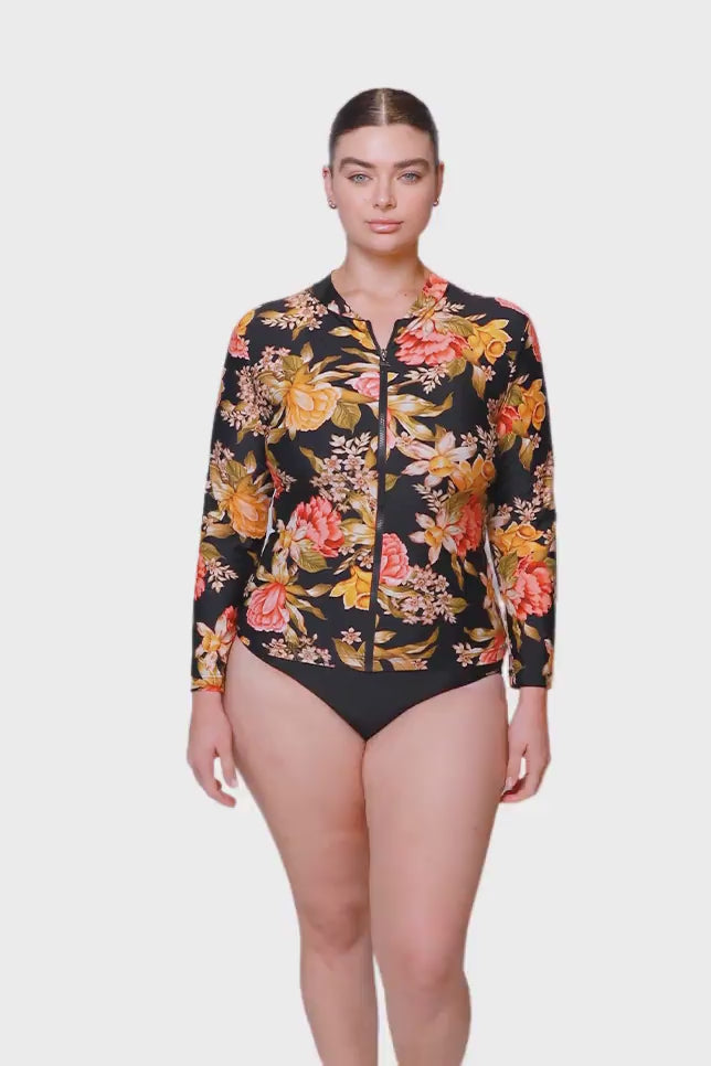 brunette women wearing long sleeve rash vest with gold and pink florals 