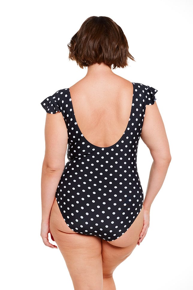Model wearing low back swimsuit with black and white dots