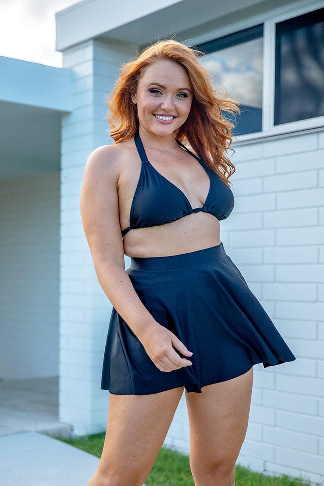 redhead model wearing black skater swim skirt
