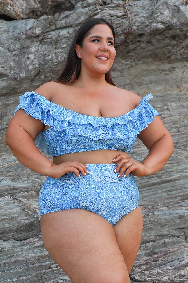 brunette model wears blue paisley bikini top with double frill detail