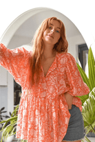 Model wearing peach boho peasant blouse