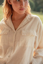 Top close up of model wearing cream Long Button Up Pyjamas