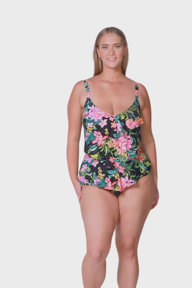blonde model wearing tropical print one piece with 3 ruffle frills on the front