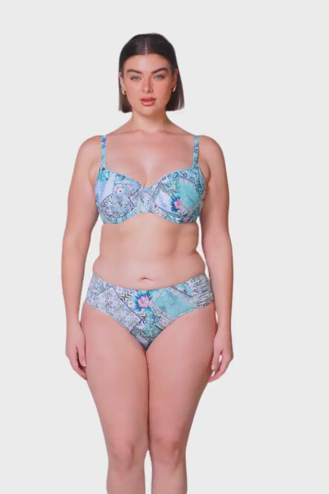 brunette women wearing mid rise aqua blue bikini bottoms with ruching on the side