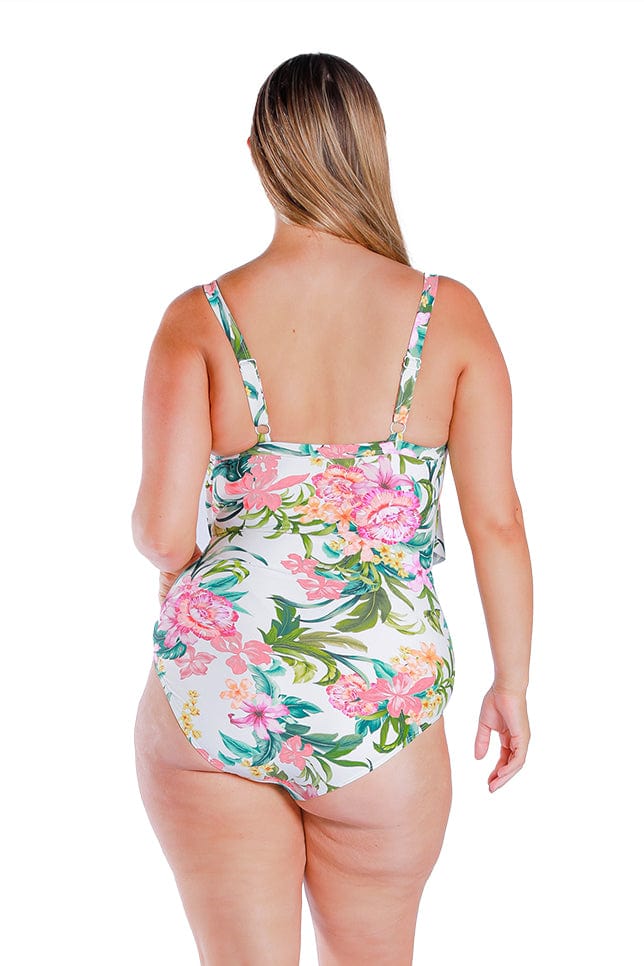 blonde model wears full coverage white floral one piece with adjustable straps