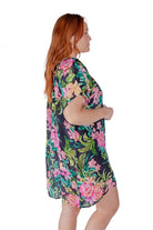 Redhead model wears tropical print mesh beach cover up