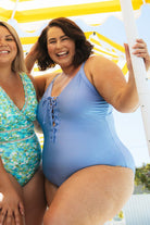 model wearing metallic plunge front with tie up one piece ladies swimsuit