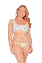 model wearing low rise retro floral swim pants with adjustable ties