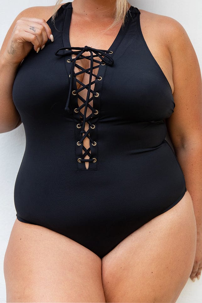 model wears black corset lace up one piece swimsuit